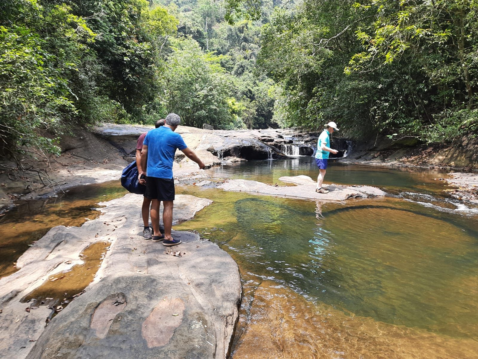Hikers exploring waterfall rocks on a highland excursion