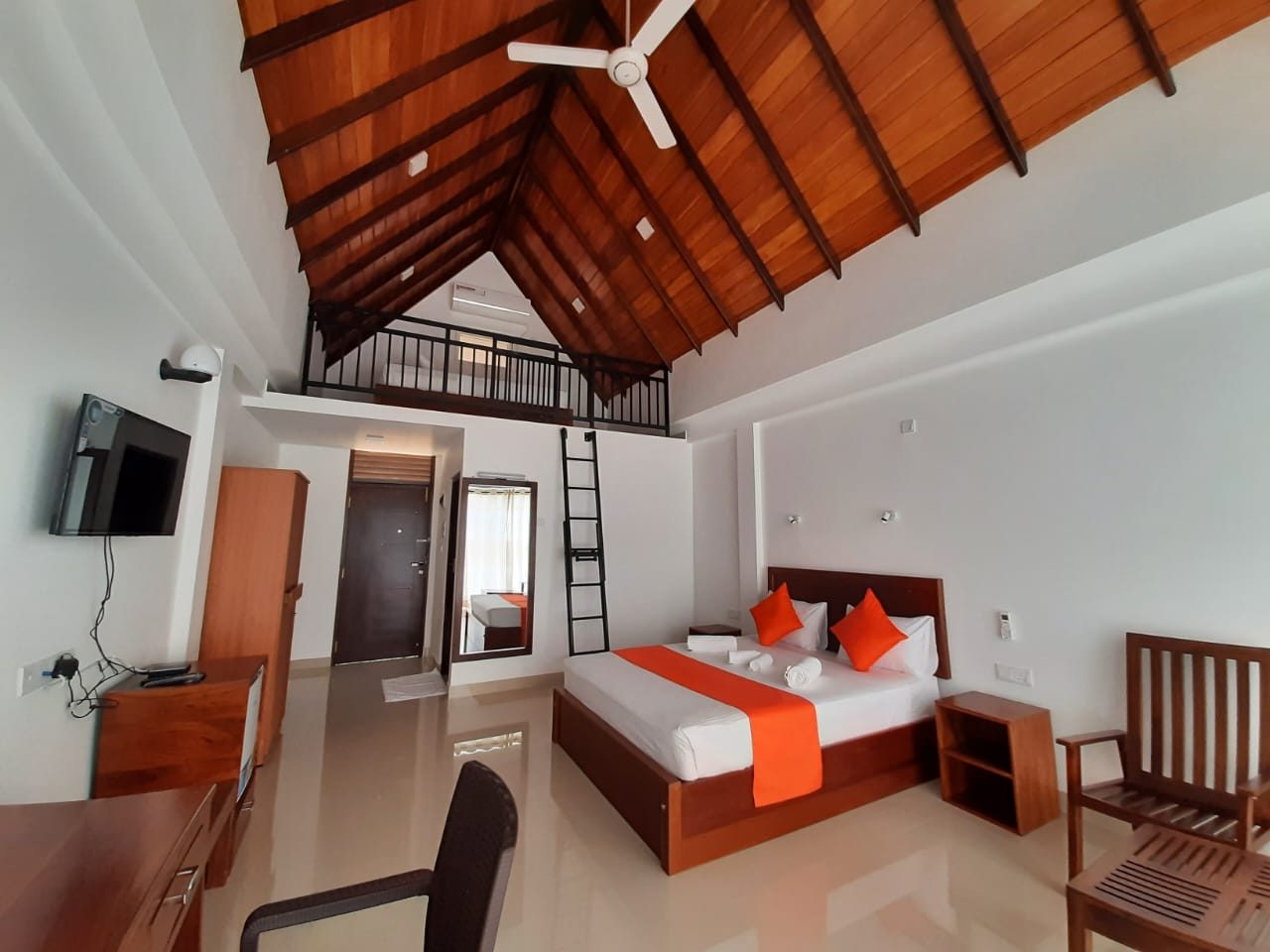 Terrace Cinnamon View loft room interior with wooden vaulted ceiling, orange theme